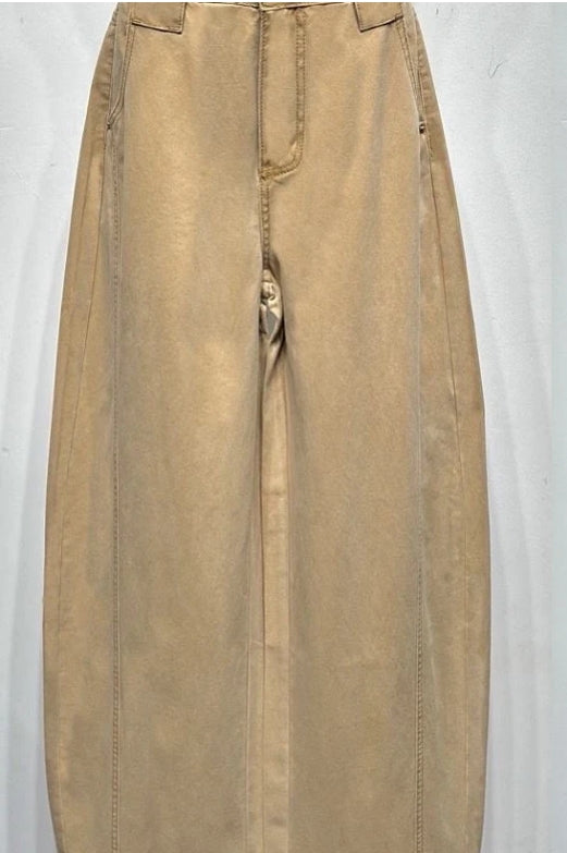 Femme habillée d’un jean coupe large vert kaki avec pull oversize assorti, posant dans un décor lumineux